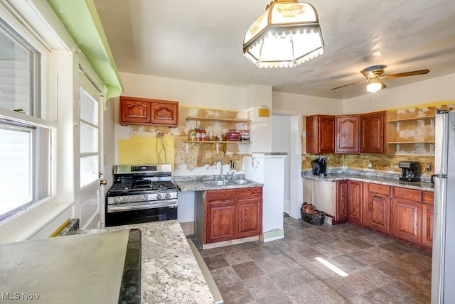 kitchen with tasteful backsplash, ceiling fan, sink, and stainless steel appliances