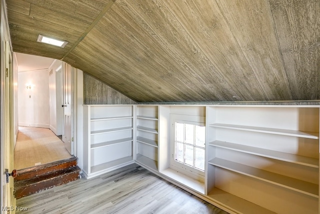 additional living space with hardwood / wood-style flooring, lofted ceiling, and wood ceiling