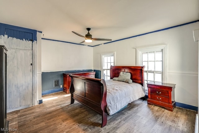 bedroom featuring hardwood / wood-style floors and ceiling fan