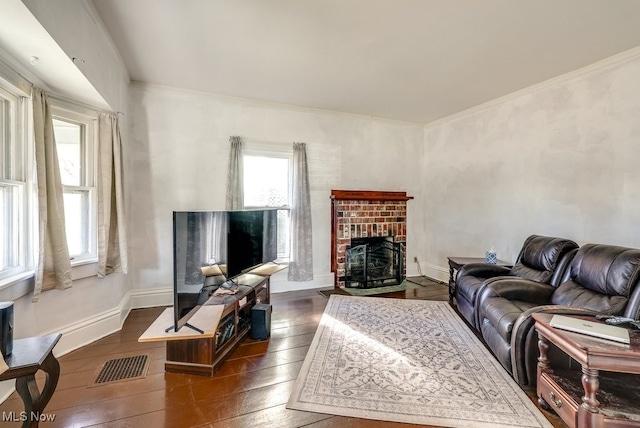 living room with dark wood-type flooring and ornamental molding