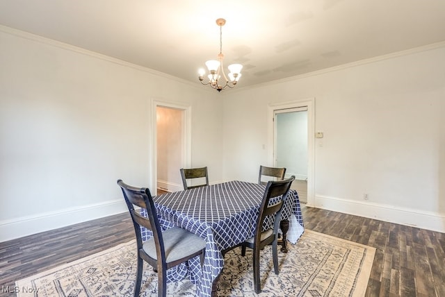 dining room featuring crown molding, a chandelier, and dark hardwood / wood-style floors