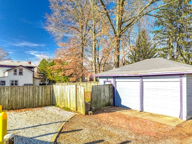 view of yard featuring a garage and an outbuilding