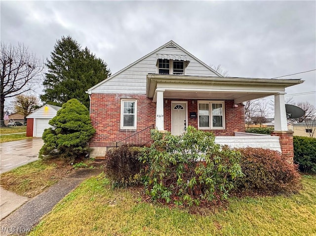 bungalow-style home with covered porch and an outdoor structure