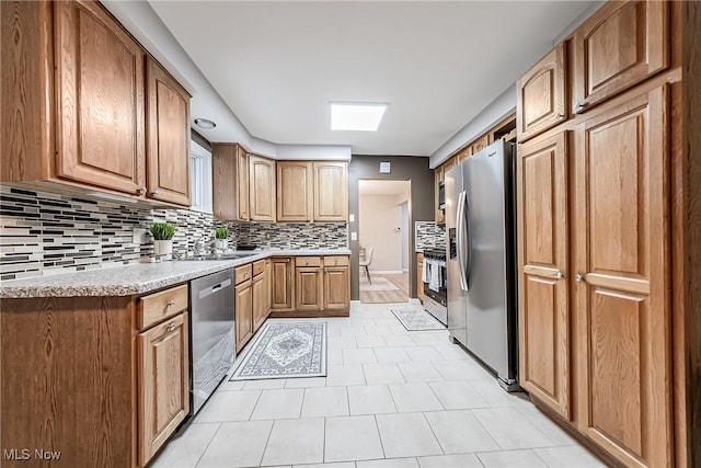 kitchen featuring stainless steel appliances and tasteful backsplash