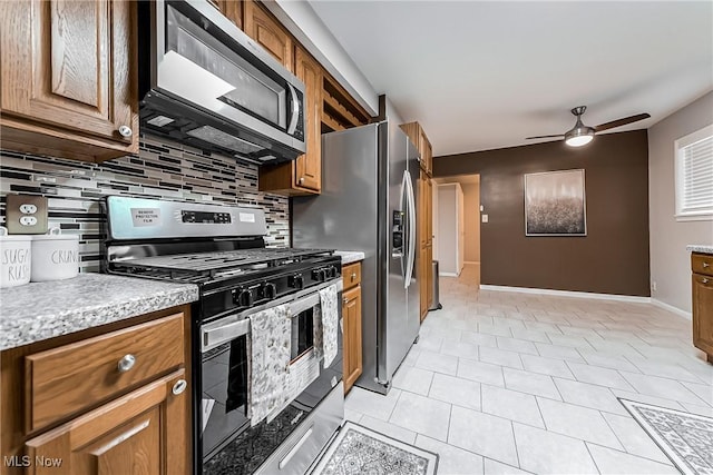 kitchen with ceiling fan, backsplash, and appliances with stainless steel finishes