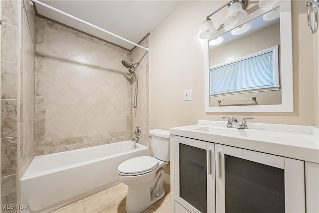 full bathroom featuring tiled shower / bath, tile patterned flooring, vanity, and toilet