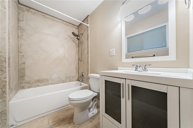 full bathroom with tile patterned floors, vanity, toilet, and tiled shower / bath combo