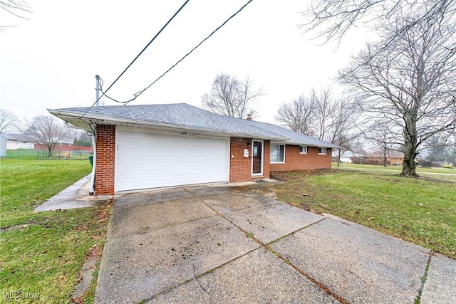 single story home featuring a garage and a front lawn