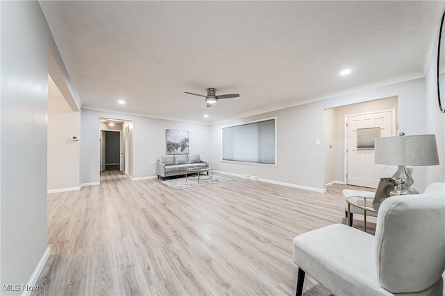 living room with ceiling fan and light wood-type flooring