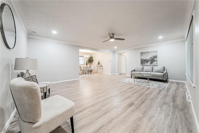 sitting room with light hardwood / wood-style flooring and ceiling fan