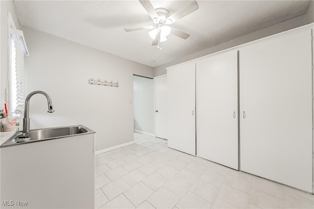 laundry area featuring ceiling fan and sink