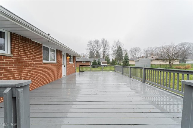 wooden terrace with a lawn