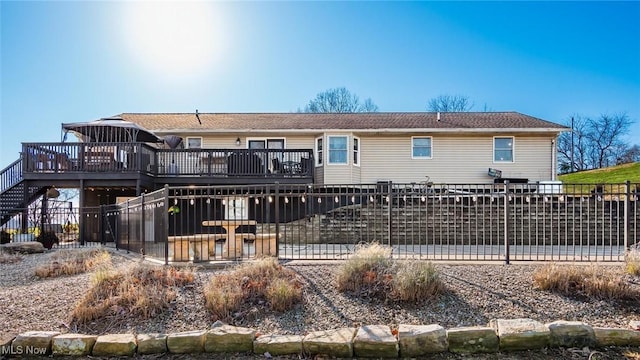 back of property with a wooden deck