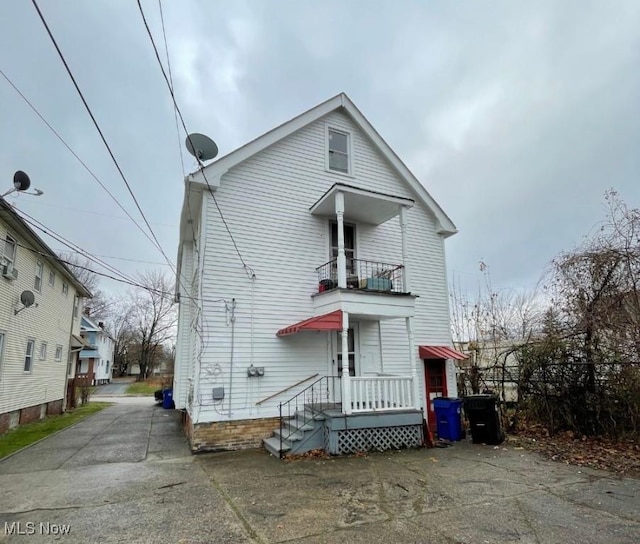 back of property with a balcony