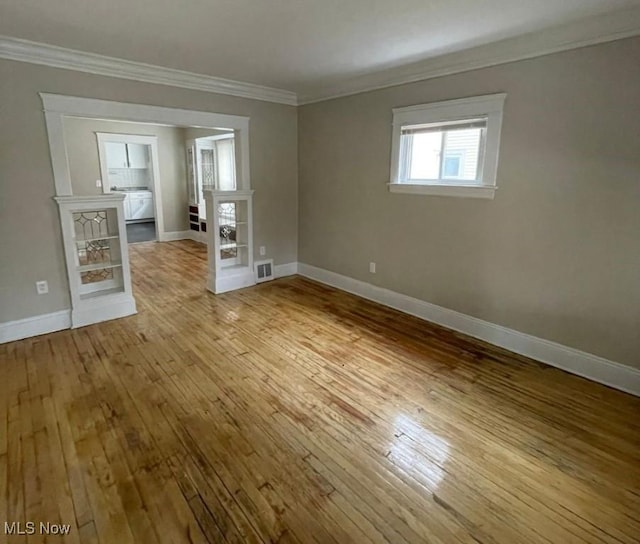 spare room featuring light hardwood / wood-style floors and ornamental molding