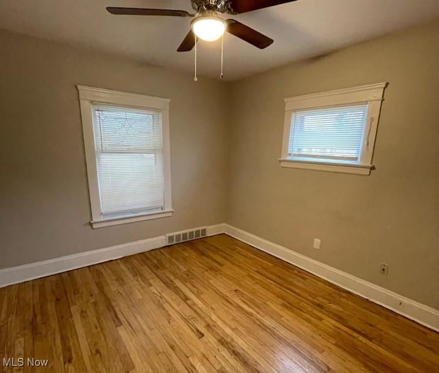 spare room featuring light hardwood / wood-style flooring and ceiling fan