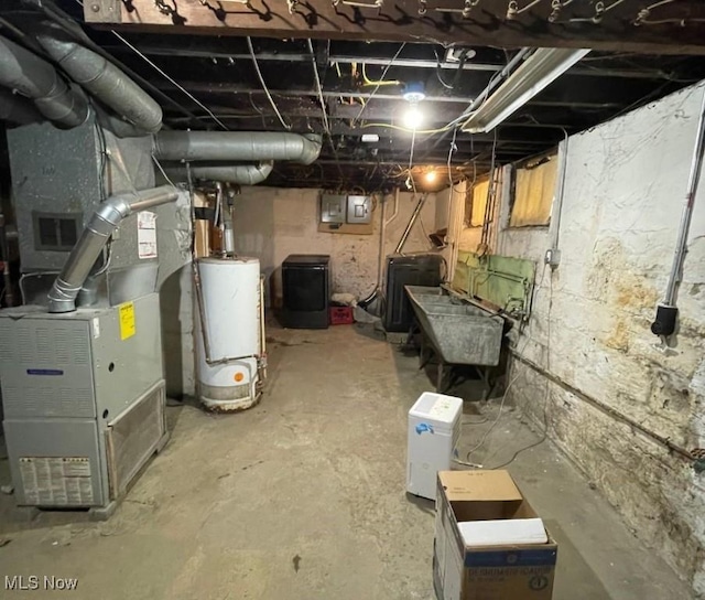 basement featuring heating unit, electric panel, and water heater