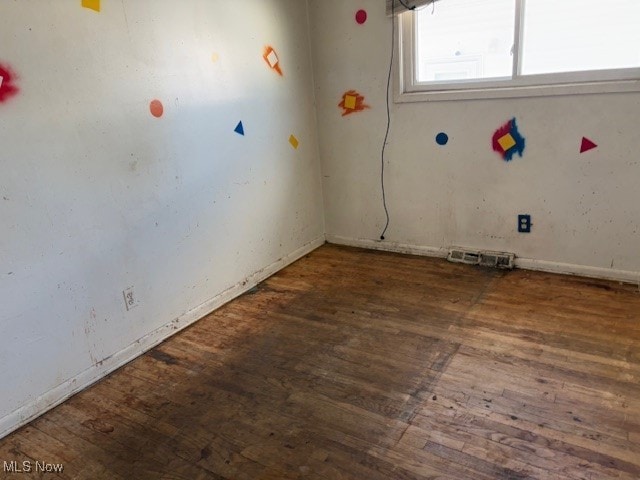 empty room featuring dark hardwood / wood-style flooring