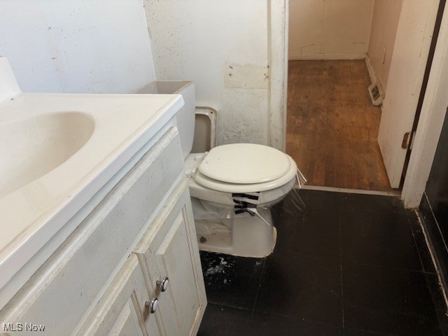 bathroom with vanity, wood-type flooring, and toilet