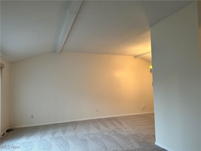 carpeted empty room with lofted ceiling with beams