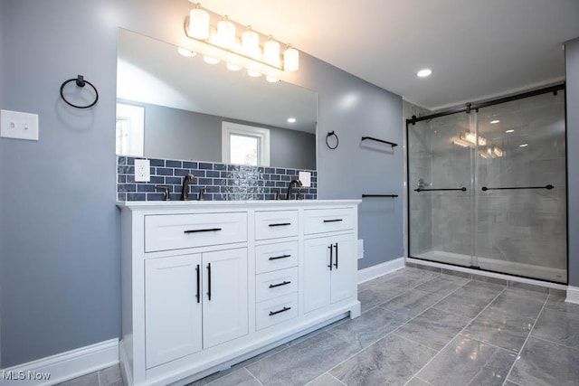 bathroom featuring decorative backsplash, walk in shower, and vanity