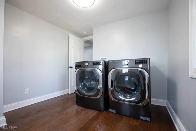 laundry room featuring washer and clothes dryer and dark wood-type flooring