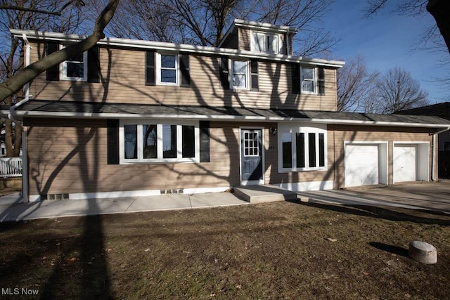 rear view of house featuring a garage