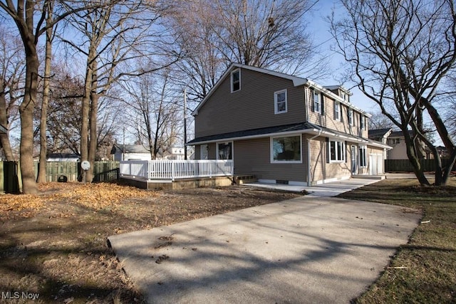 view of property exterior with a wooden deck