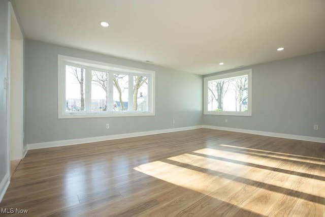 unfurnished room with hardwood / wood-style flooring