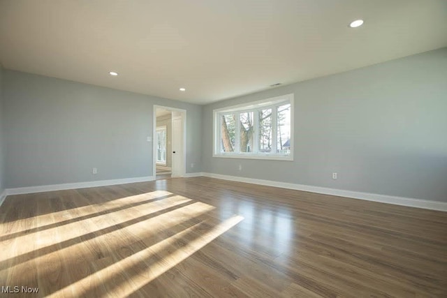 spare room with dark hardwood / wood-style floors