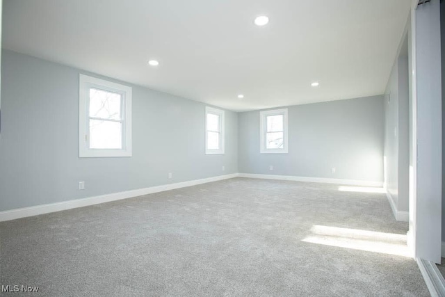 empty room with plenty of natural light and light colored carpet