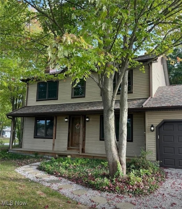 view of front facade with covered porch and a garage