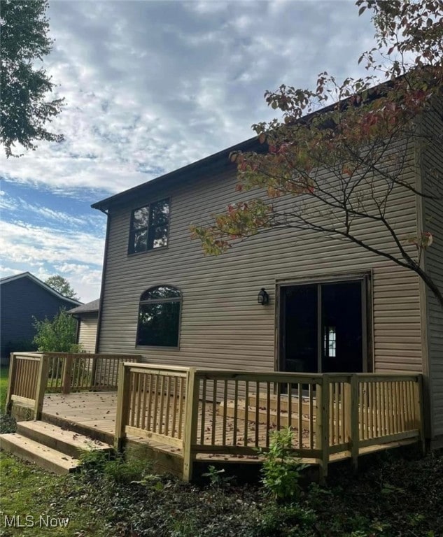 rear view of property with a wooden deck