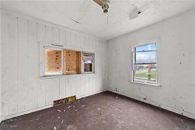 unfurnished room featuring a textured ceiling