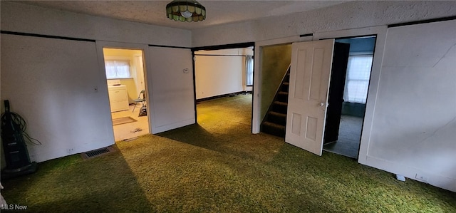 unfurnished bedroom with dark colored carpet