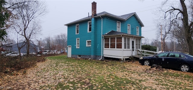 rear view of property with a sunroom