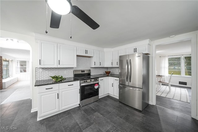 kitchen with white cabinets, dark hardwood / wood-style flooring, stainless steel appliances, and tasteful backsplash