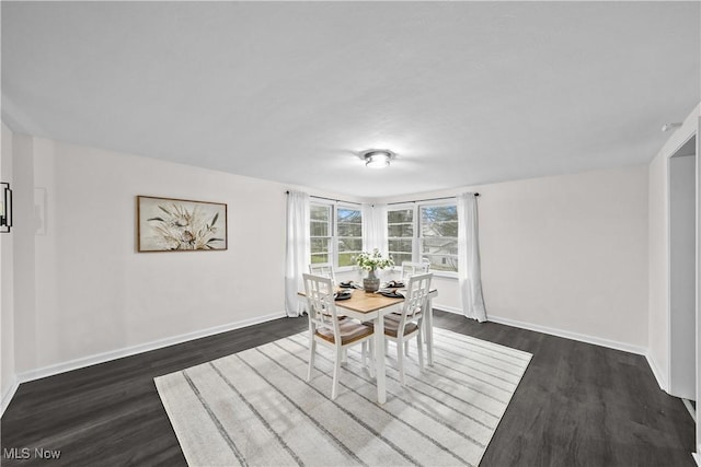 dining area with dark hardwood / wood-style floors