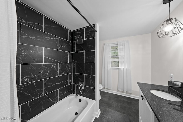 full bathroom with vanity, tiled shower / bath combo, and toilet