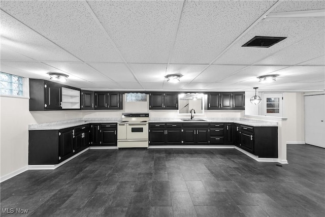 kitchen featuring white electric range oven, pendant lighting, a paneled ceiling, and sink