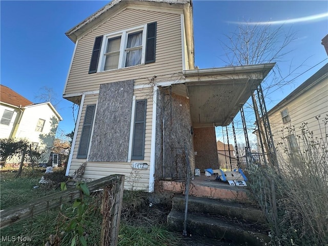 view of side of home with fence