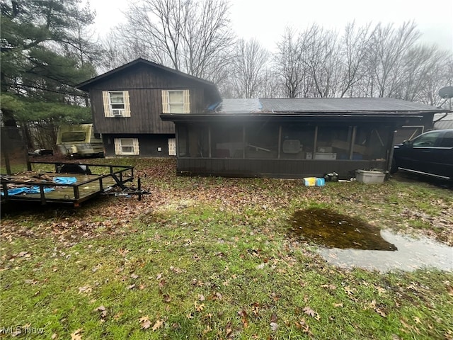 rear view of property with a sunroom