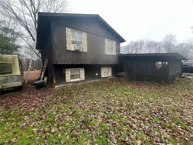 back of property featuring a sunroom and cooling unit