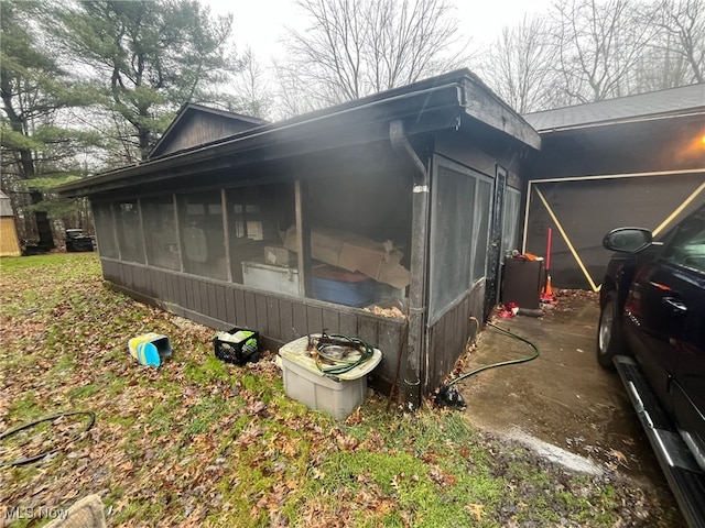 view of side of home with a sunroom