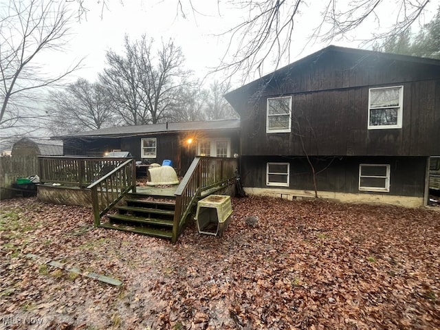 rear view of property featuring a deck