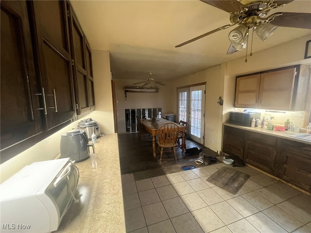 interior space with light tile patterned floors, french doors, and sink