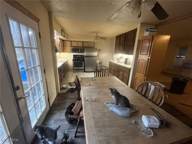 dining space featuring tile patterned flooring and ceiling fan