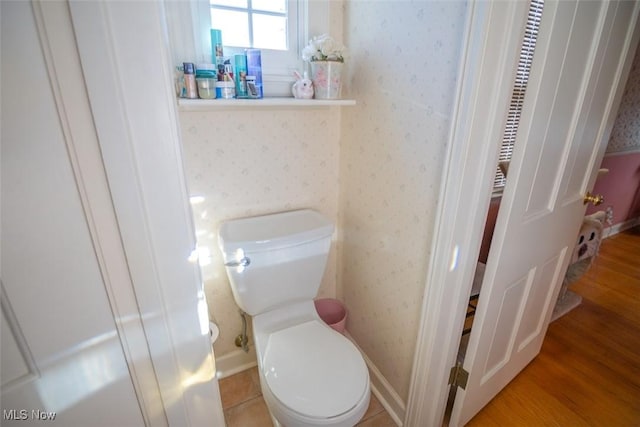 bathroom featuring hardwood / wood-style floors and toilet