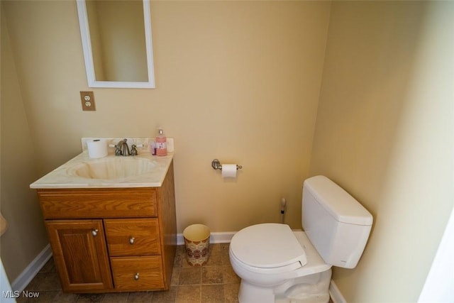 bathroom featuring tile patterned flooring, vanity, and toilet