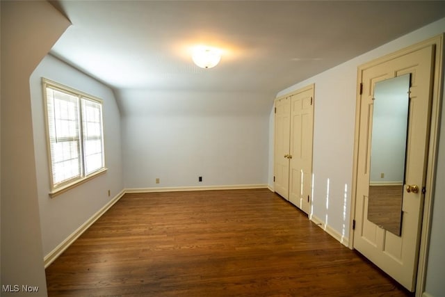 bonus room featuring dark hardwood / wood-style flooring and vaulted ceiling